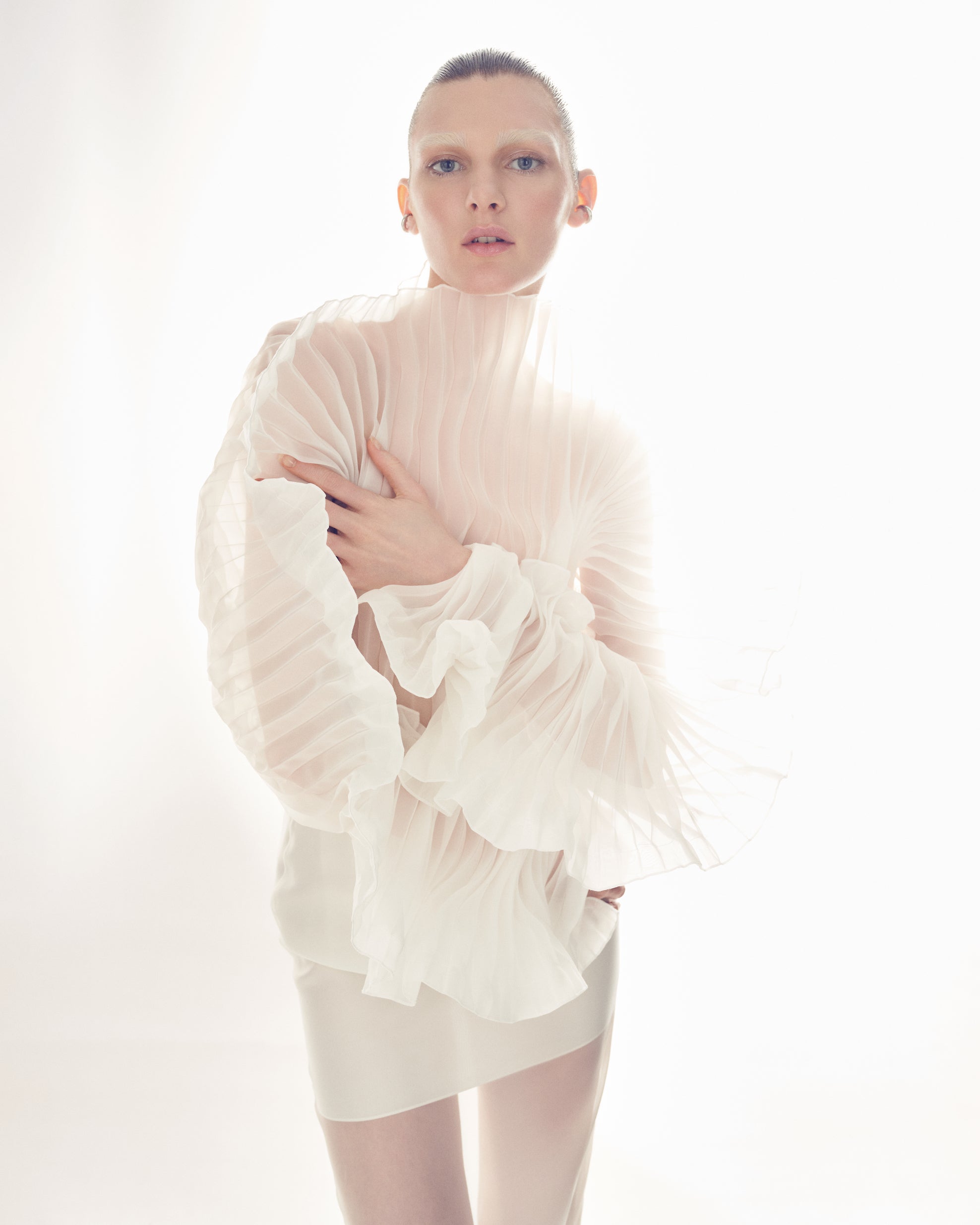 Fleur Set by J'amemme — close-up of model wearing white pleated bridal top with dramatic ruffled sleeves