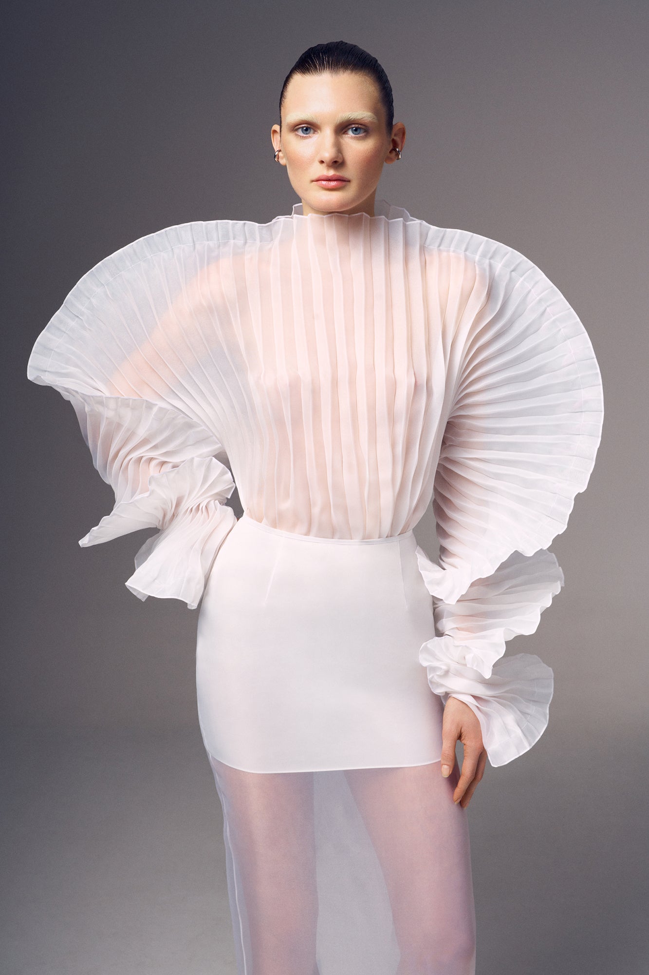 Fleur Set by J'amemme — model wearing white pleated bridal top and skirt set, front view with dramatic sleeves