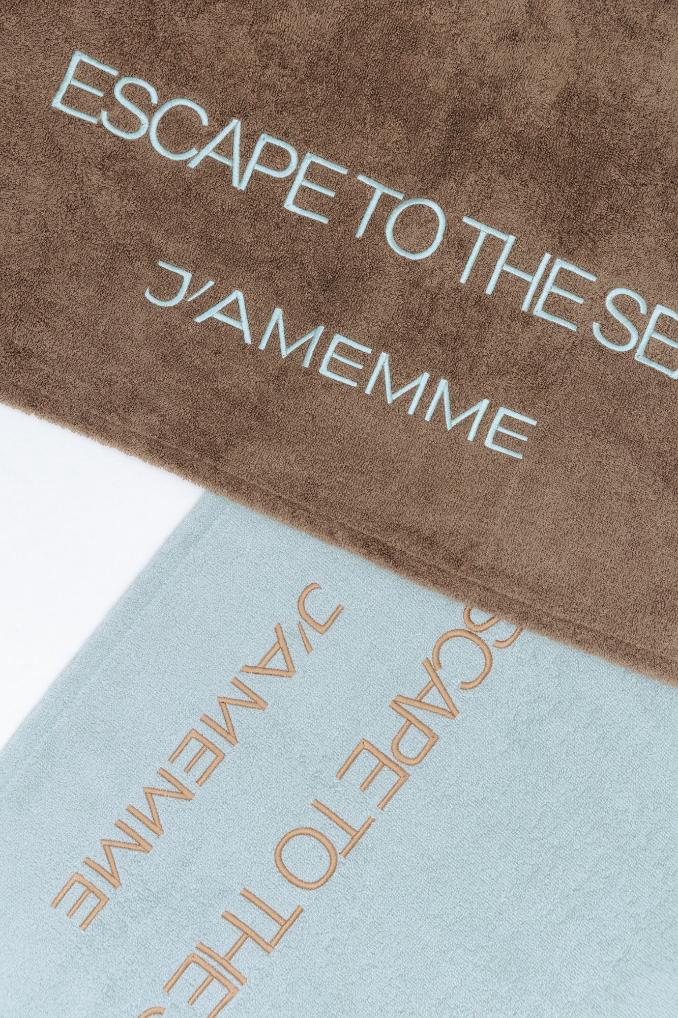 Detail of the 'Escape To The Sea' embroidery on the chocolate cotton beach towel — J'AMEMME