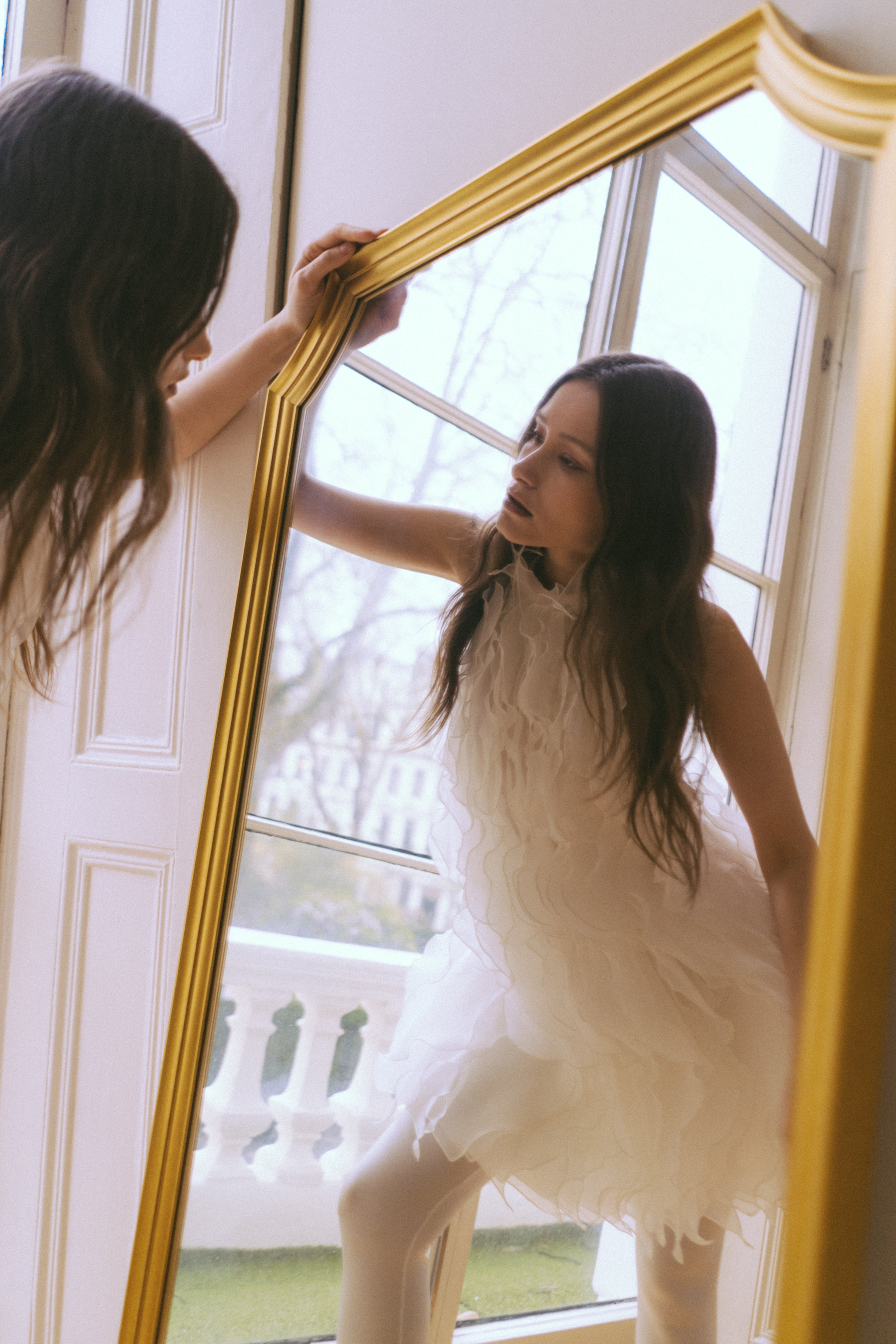 Wave White Dress by J'amemme — editorial shot of model in ruffled bridal mini dress by mirror
