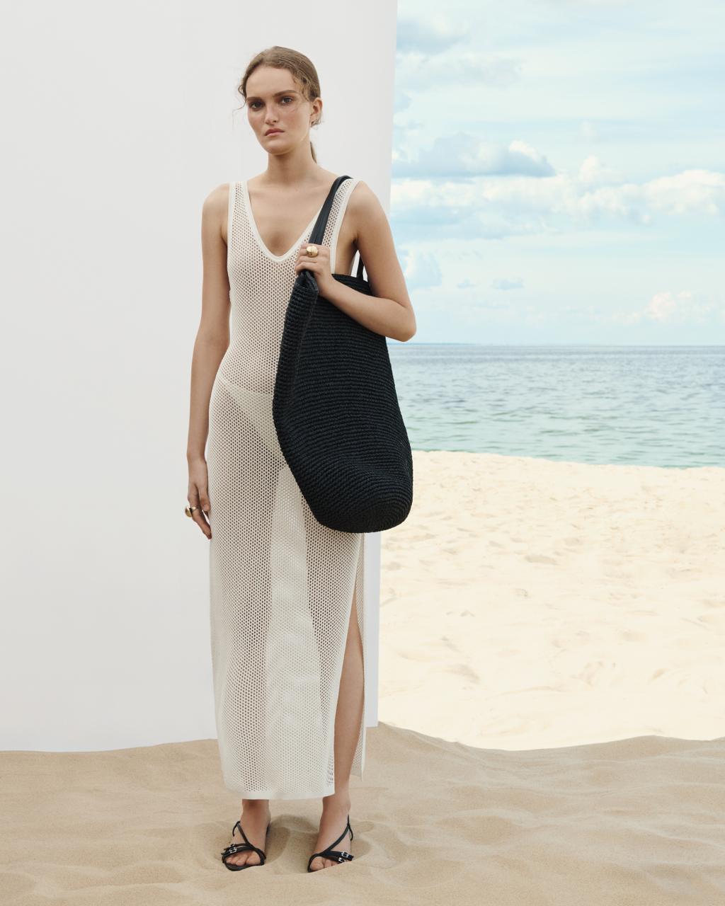 Model wearing the beige Nereis open-knit mesh beach dress over swimwear — J'AMEMME Resort '27