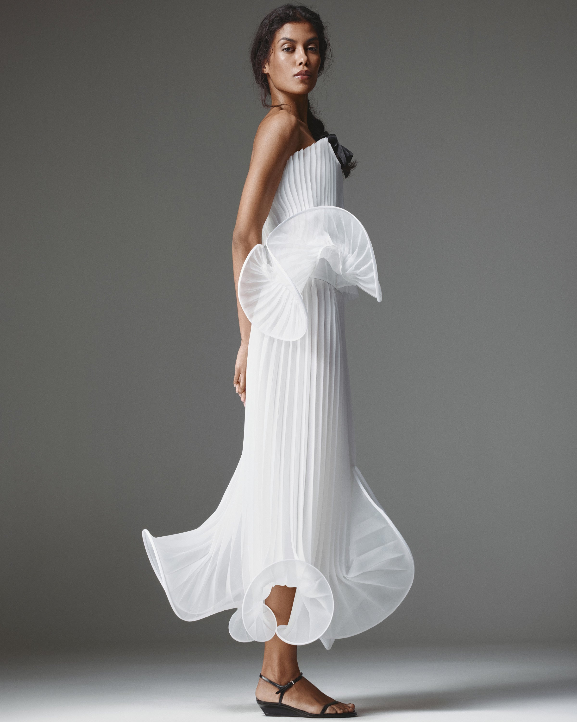 Nina Pleated Set by J'amemme — side view showing pleated peplum top and matching pleated skirt with ruffled hem