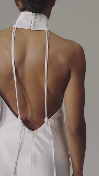 Devon Dress by J'amemme — movement video of the white satin halter wedding gown showing the open back and fluid column skirt.