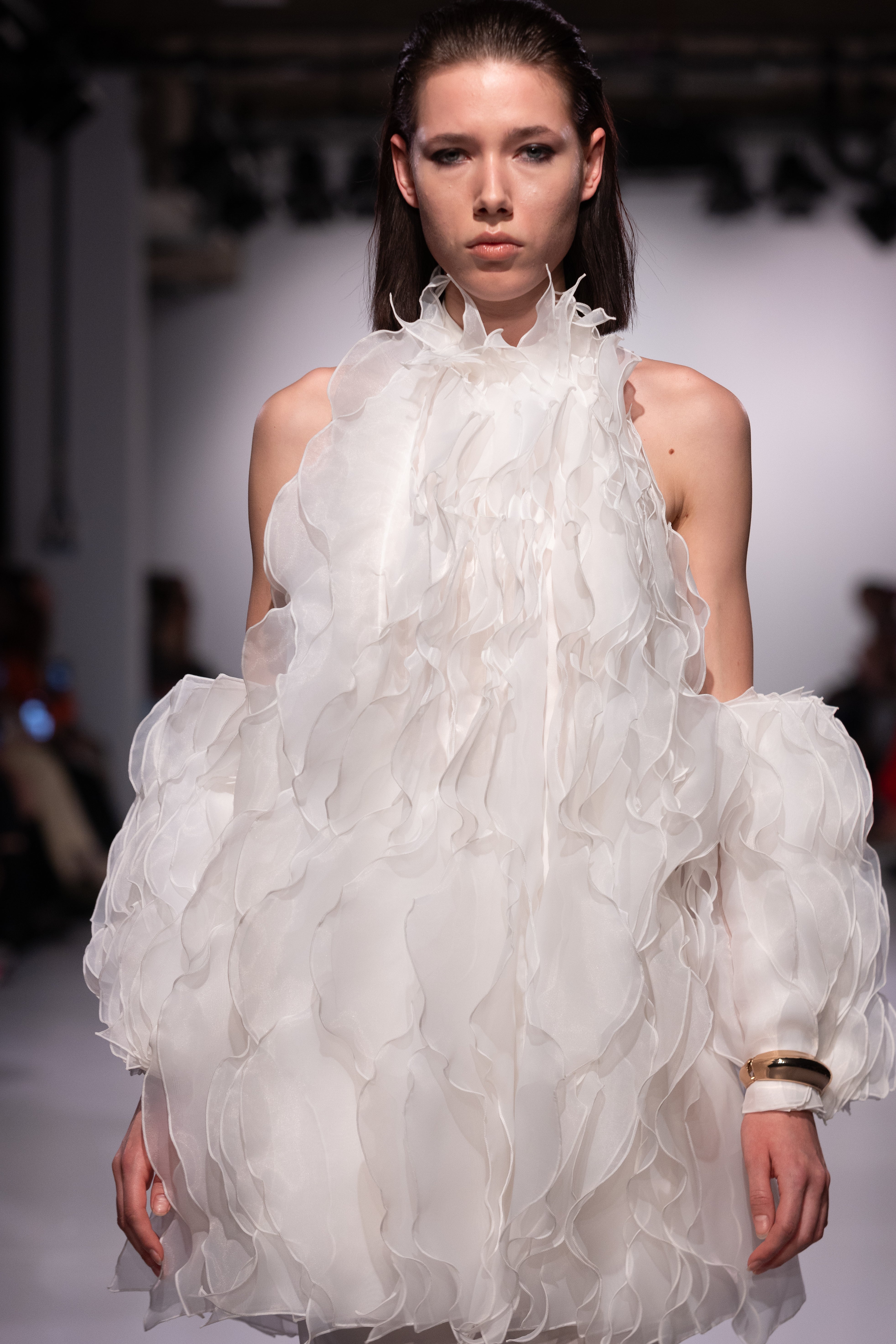 Wave White Dress by J'amemme — close-up runway detail of cascading organza ruffles on bridal mini dress